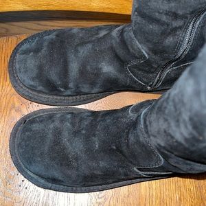 Tall black UGG sheepskin boots with zipper on side